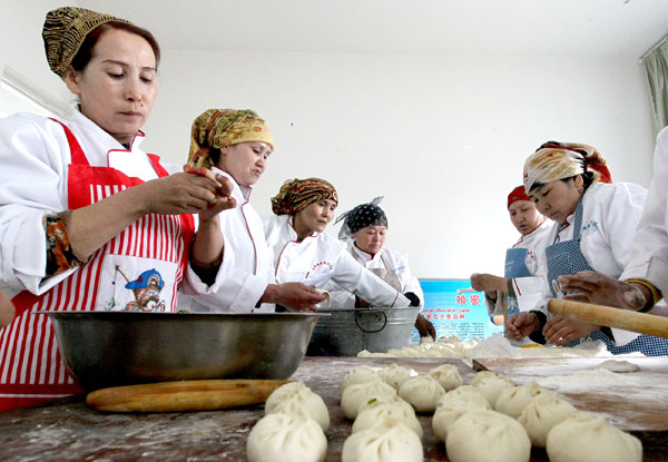 Women practice making steamed stuffed bans in Huayuan county, March 11, 2013. New skills for better jobs in Xinjiang