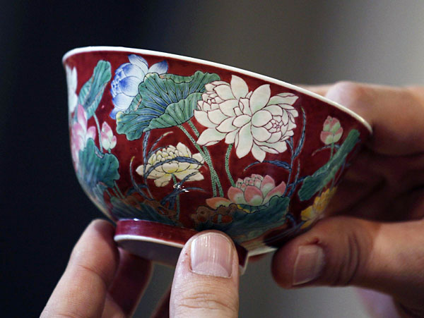 A magnificent Ruby-Ground Falangcai 'Double-Lotus' Bowl Blue Enamel Yuzhi Mark and Period of Kangxi is shown after Hong Kong Chinese ceramics dealer William Chak has bought it for HK$74 million ($9.5 million) at Sotheby's Spring Sales in Hong Kong, April 8, 2013. New auction record set for Kangxi porcelain