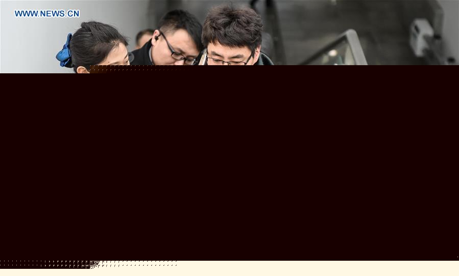 Young couple as railway workers busy for Spring Festival travel rush