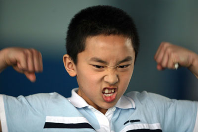 A student practices Wushu, a traditional martial art, at the Shi Cha Hai boarding sports school in Beijing April 5, 2006. The school is famous for training students for competitive sports from national tournaments to the Olympic games. [Reuters]