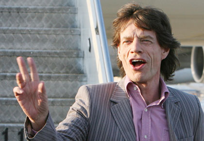 Mick Jagger of the Rolling Stones gestures as he arrives at the Pudong international airport in Shanghai, China April 6, 2006. The band arrived in Shanghai on Thursday afternoon in preparation for a concert on Saturday, their third attempt to play in China. 