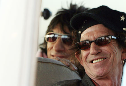 Keith Richards (R) and Ron Wood (L) of the Rolling Stones sit in a bus upon arrival at the Pudong international airport in Shanghai, China April 6, 2006. The band arrived in Shanghai on Thursday afternoon in preparation for a concert on Saturday, 