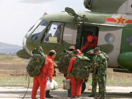 Chinese firemen board an helicopter on their way to put out forest fire in Heihe