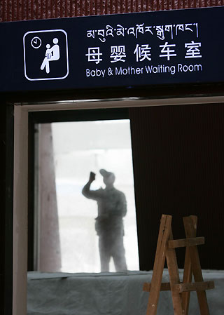 A worker makes final touches at the nearly finished Lhasa Railway Station in Lhasa, Tibet, June 24, 2006. The Qinghai-Tibet Railway, which will begin trial operations on July 1, 2006. Picture taken June 24, 2006. 