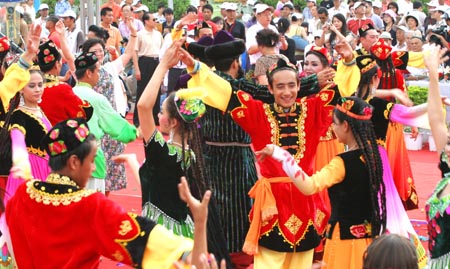 Local residents perform to celebrate the opening of the third Xinjiang International Tourism Festival as well as the 15th China Silk Road Turpan Grape Festival Wednesday, June 28, 2006. The event will last two months until August 28, 2008. [newsphoto]