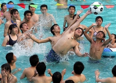Residents take to a game of water polo to cool off in Wuhan, central China's Hubei province, Sunday, July 2 2006. A heat wave is expected to hit parts of China over the next week with temperatures reaching up to 37 Degree Celsius (98 degrees Fahrenheit). 