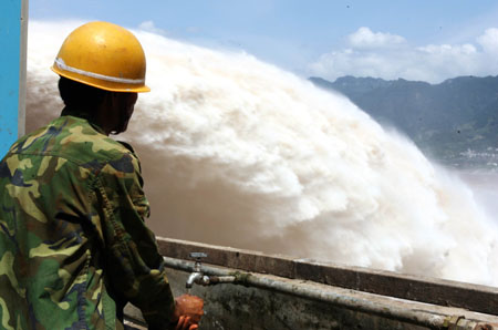 Floodwater gushes out from the eight-hole sluice gate on the Three Gorges Dam Tuesday, July 18, 2008. The hydro-power project, the world's largest of its kind, has played an active role in storing the floodwater and lagging flood peak during the summer flood season ever since the tearing down of the cofferdam on June 6 this year. It is the first time the sluice gate was raised to release floodwater from the reservoir. [newsphoto]