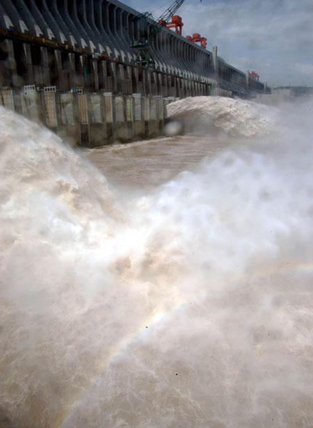 Floodwater gushes out from the eight-hole sluice gate on the Three Gorges Dam Tuesday, July 18, 2008. The hydro-power project, the world's largest of its kind, has played an active role in storing the floodwater and lagging flood peak during the summer flood season ever since the tearing down of the cofferdam on June 6 this year. It is the first time the sluice gate was raised to release floodwater from the reservoir. [newsphoto]