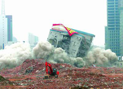 An 8-storied building is demolished with a controlled explosion for reconstruction in Zhengzhou, Central China's Henan Province August 2 2006. [Photo by Pan Yongjun]