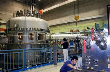 In this photo released by China's official Xinhua news agency, a scientist debugs the Experimental Advanced Superconducting Tokamak (EAST) in the Institute of Plasma Physics of Chinese Academy of Sciences in Hefei, east China, on Thursday September 28, 2006. Scientists on Thursday carried out China's first successful test of an experimental fusion reactor, powered by the process that fuels the sun, a research institute spokeswoman said. China, the United States and other governments are pursuing fusion research in hopes that it could become a clean, potentially limitless energy source. Fusion produces little radioactive waste, unlike fission, which powers conventional nuclear reactors. (AP 