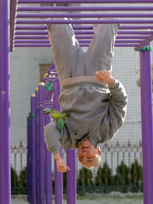 Wang Yongyou, 70, does exercise with the fitness equipment at a community in Huaibei City, East China's Anhui Province January 8, 2007. Wang was familiar with all the 45 sets of fitness equipments at the community and could make stunning performance, local residents said. [Wang Wen/Xinhua]