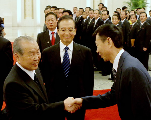 DPRK Prime Minister Choe Yong-rim (left) meets officials at a welcoming ceremony in the presence of Premier Wen Jiabao in the Great Hall of the People in Beijing on Monday. Development path 'must suit DPRK'