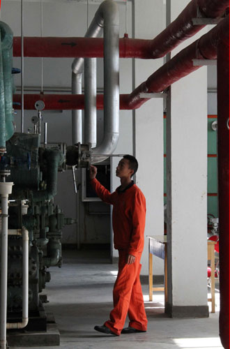 A technician examines a machine at the Jiuquan Satellite Launch Center in Northwest China's Gansu province, Sept 28, 2011. One small step for Tiangong-1