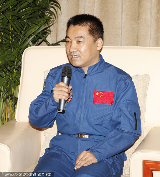 Shenzhou X astronauts Wang Yaping, Nie Haisheng and Zhang Xiaoguang salute at a news conference at Beijing Aerospace City on July 11, 2013, after they were released Thursday from their medical quarantine and given the medical all clear. Shenzhou X astronauts out of quarantine