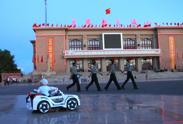The city in the Gobi desert enjoys a continental desert climate. Residents are seen enjoying the comfortable summer weather in the city square. Home of space dreams