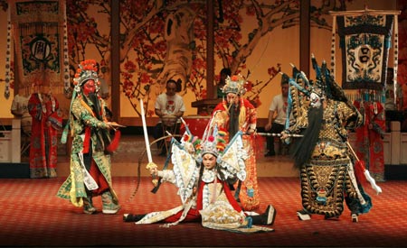 Actors perform during a Sichuan Opera show at the Jingjiang Theatre in Chengdu, southwest China's Sichuan province May 25, 2007. Sichuan Opera, which is distinguished by the face-changing technique where performers change masks in quick succession with a wave of the hand or by turning around, is one of the oldest forms of Chinese opera. 