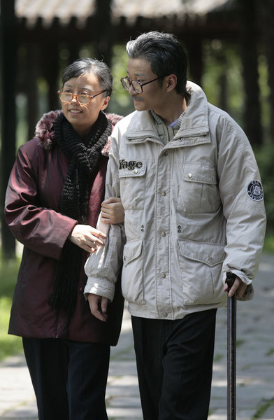 Yao Zhenni holds her husband Zhang Jing's arm while taking a walk in a video, which is made to show their love later in life, to celebrate their marriage at the Bailuzhou Park in Nanjing, East China's Jiangsu province, July 3, 2011. The joys of 50 years of marriage captured