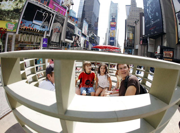 Tourists sit in the art installation 'Meeting Bowls' by the Spanish collaborative mmmm in Times Square in New York August 17, 2011. 'Meeting Bowls' in Times Square