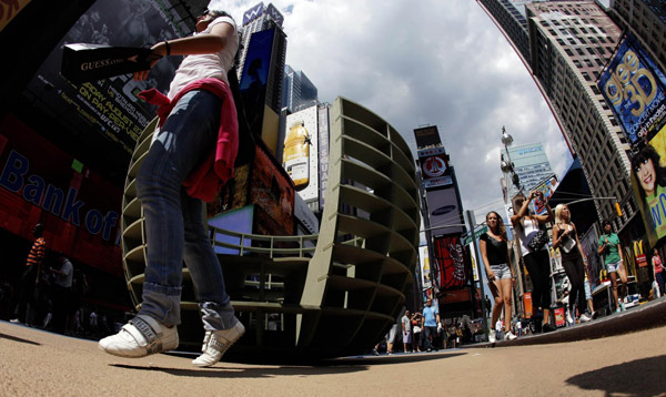 A tourist exits the art installation 'Meeting Bowls' by the Spanish collaborative 'mmmm' in Times Square in New York August 17, 2011. 'Meeting Bowls' in Times Square