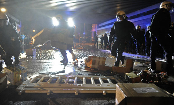 Police forces remove a street barricade during clashes at the so-called street party 'Schanzenfest' in the Schanze district in Hamburg August 20, 2011. Demonstrators clash with police in Hamburg