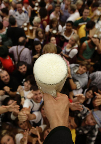 Revellers scuffle for the first free beer in the traditional 1-litre beer mug at the opening of the World's biggest beer fest, the Munich Oktoberfest, at the Theresienwiese in Munich, September 17, 2011. World's biggest beer fest opens in Munich