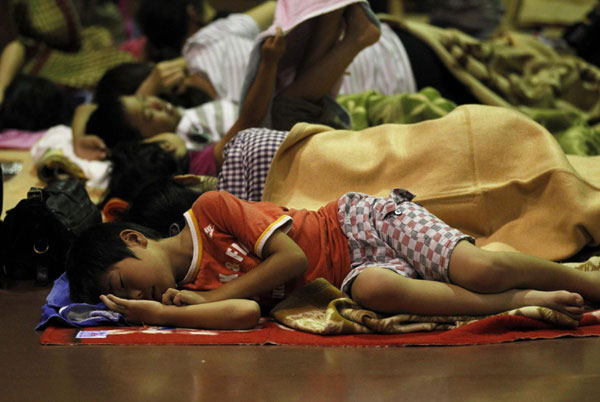 Evacuees rest at an evacuation center in Nagoya, after the area was flooded due to typhoon Roke approached, central Japan, September 20, 2011. Typhoon Roke lashes Japan, killing at least 6