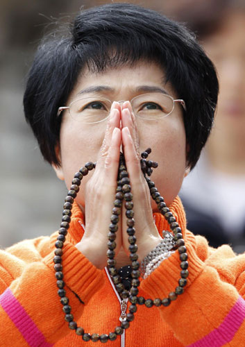 A mother prays for her child's success in the college entrance examinations at a Buddhist temple in Seoul Nov 9, 2011. Koreans praying for offsprings' future