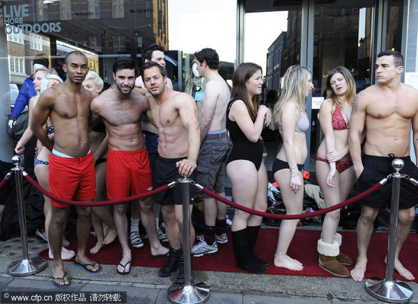 A crowd of people wearing swimsuits line up in freezing cold outside a new Virgin Holidays store, Dec 13, 2011. Brits strip for world record, cheap holidays