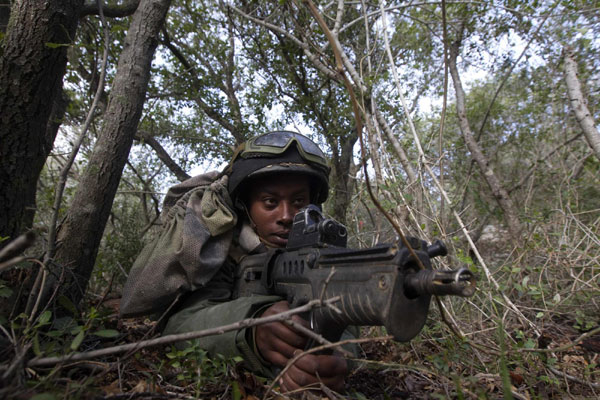 An Israeli soldier lies in ambush during an exercise in northern Israel, simulating battle conditions in Lebanon, January 18, 2012. Israeli soldiers simulate battle conditions