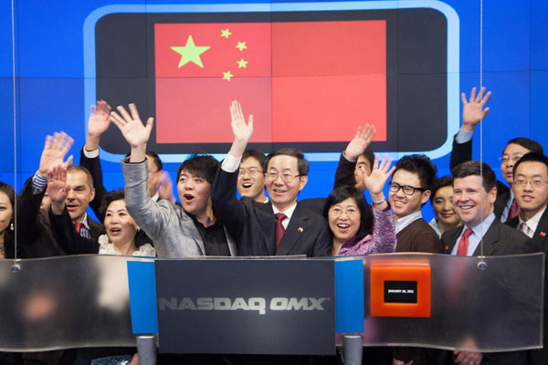 Chinese Ambassador Guoxiang Sun (R) and pianist Lang Lang ring the NASDAQ Stock Market Opening Bell in celebration of Chinese New Year in New York January 20, 2012 in this NASDAQ handout photo. NASDAQ opening bell hails Chinese New Year