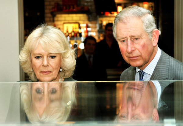 Britain's Prince Charles and his wife Camilla, Duchess of Cornwall, travel on a Metropolitan line tube train from Farringdon station to King's Cross station, as they mark 150 years of the London Underground Jan 30, 2013. Prince Charles and Camilla surprise 'Tube' passengers