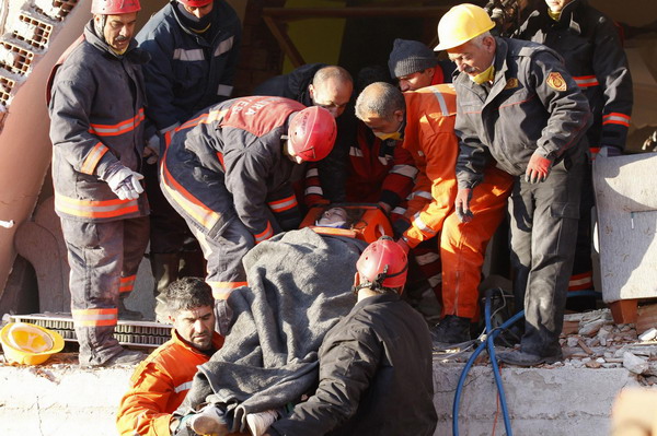 Tugba Ozbek, a 24-year-old high school teacher and earthquake survivor, is carried out on a stretcher by rescue workers, from a collapsed building after an earthquake in Ercis, near the eastern Turkish city of Van, October 24, 2011. Turkey quake death toll exceeds 260