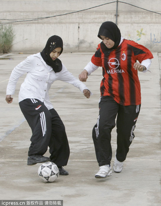 Iraqi girls play during a female youth soccer tournament in the Shiite enclave of Sadr City in Baghdad, Iraq, on March 13, 2008. Public sports in post-war Iraq