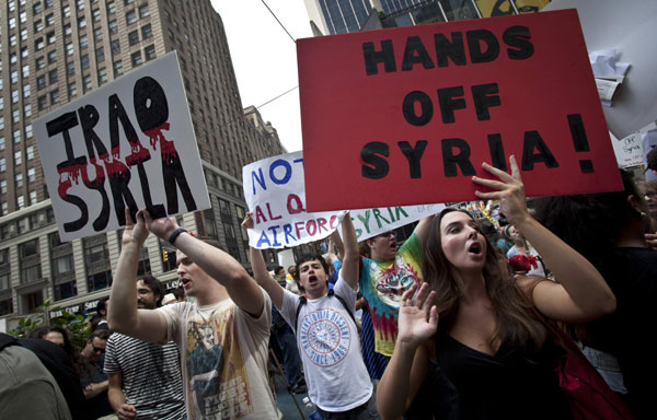 People protest against proposed US military action against Syria, in Times Square in New York, Aug 31, 2013. Obama delays strike against Syria to seek Congress approval