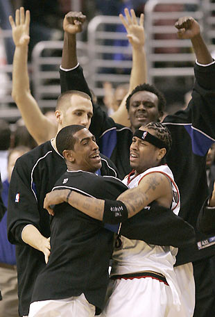 Philadelphia 76ers guard Kevin Ollie (front L) hugs guard Allen Iverson (front R) after their 125-124 NBA win over the Boston Celtics in Philadelphia January 13, 2006. Teammates Shavlick Randolph (rear left) and Samuel Dalembert join the celebration.