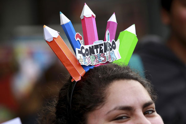 A demonstrator wears a sign that reads 'Content + expression' during a student rally against the government's public education system in Santiago city September 22, 2011. Chile: Students riot demanding education reform