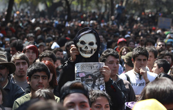 Demonstrators gather as a protester holds up a skull mask during a student rally against the government's public education system in Santiago city September 22, 2011. Chile: Students riot demanding education reform