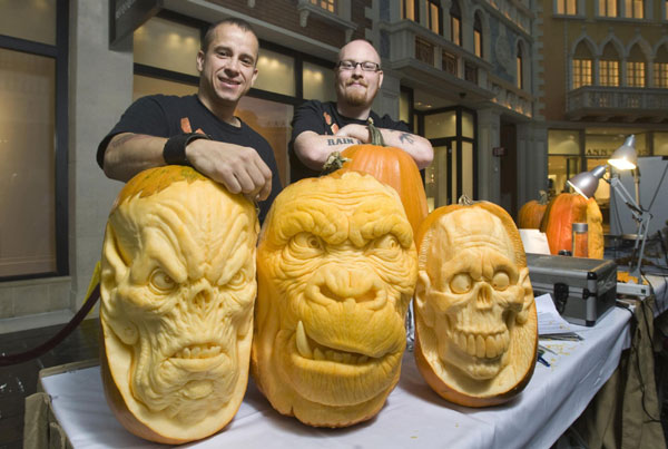 Artists Ray Villafane (L) and Andy Bergholtz pose during a pumpkin carving exhibition in the Grand Canal Shoppes at The Venetian hotel-casino in Las Vegas, Nevada Oct 26, 2011. The pumpkins will be displayed at Heidi Klum's Halloween party and other Halloween events at the TAO and LAVO nightclubs in Las Vegas. Pumpkins make faces as Halloween comes