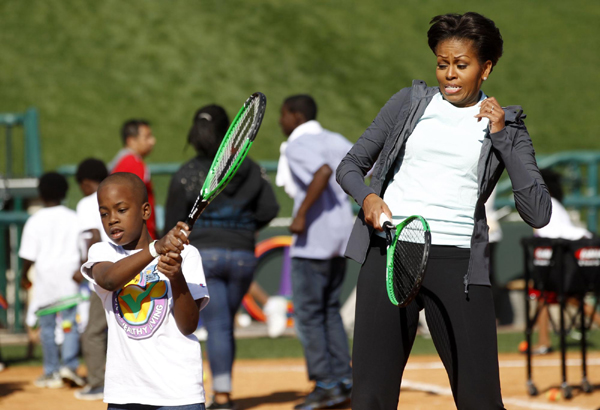 US first lady Michelle Obama plays mini-tennis during a 'Let's Move!' faith and communities physical activity at Disney World's ESPN Wide World of Sports in Orlando, Florida. 'Let's Move' with US first lady