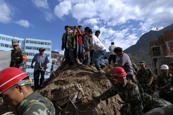 Frantic search for signs of life after landslide