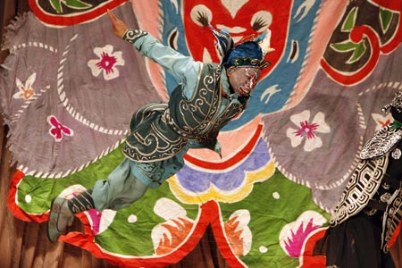 A Chinese artist performs in an English version of the traditional Chinese opera Monkey King at a theatre in Shanghai December 8, 2006. Among the performers is Ghaffar Pourazar of Britain (not in photo), the first foreigner to complete the rigorous training at the Beijing Opera School and the National Academy. He is performing with Chinese artists from the International Centre for Beijing Opera, and other troupes, at their first show in Shanghai. 