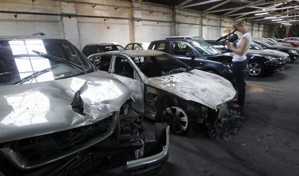 Burned cars are on display inside the police station for confiscated cars in Berlin August 18, 2011. Arson attacks on cars surge in Berlin