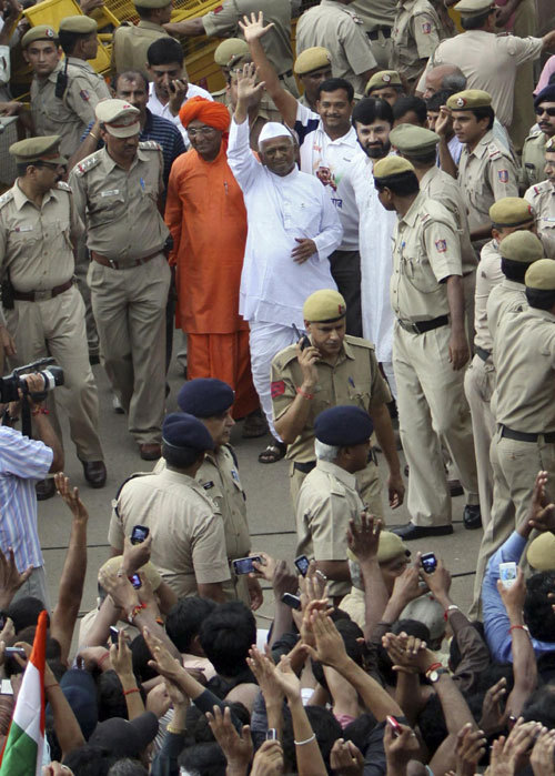 Social activist Anna Hazare waves to his supporters outside Tihar jail in New Delhi in this August 19, 2011 file photo.[ Anti-graft campaign awakens India's middle class