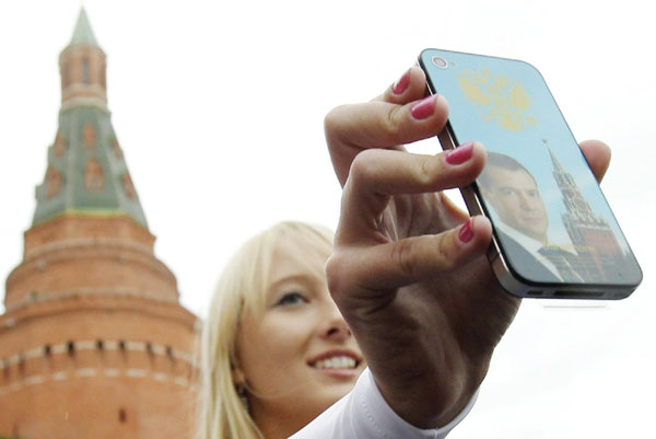 A member of a local social network group calling themselves 'Medvedev girls' displays a gift for Russian President Dmitry Medvedev's birthday to authorities in the Kremlin Sept 14, 2011. President Medvedev celebrated his 46th birthday on Wednesday. 'Medvedev girls' show gifts for Medvedev's birthday