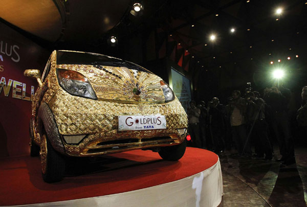 A car covered in gold, silver and gemstones is unveiled in Mumbai, India, Sept 19, 2011. The company that made the car is planning to exhibit the car in about 30 towns as part of its marketing initiative. Gold jeweler in India uses marketing bling