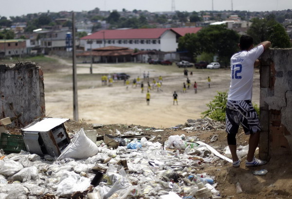 A soccer fan, wearing a jersey bearing the name of the French striker Thierry Henry, watches a 'Peladao Verde' championship match between Unidos da Amizade and Uniao Atletica Japiim in Manaus Sept 25, 2011. 'Biggest' amateur soccer games kicks off in Brazil