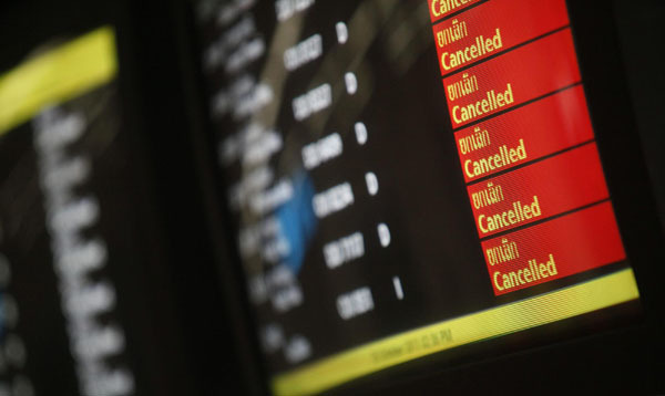 Monitors display the flights that have been cancelled at Don Muang Airport in Bangkok October 25, 2011. Floodwater reaches Bangkok's airport