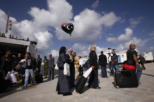 Civilians disembark from the first boat carrying travellers since Feb 2011 from Cyprus to Tripoli, at El Chaab sea port, in Tripoli, Nov 10, 2011. Tripoli sees first boat with travellers since Feb