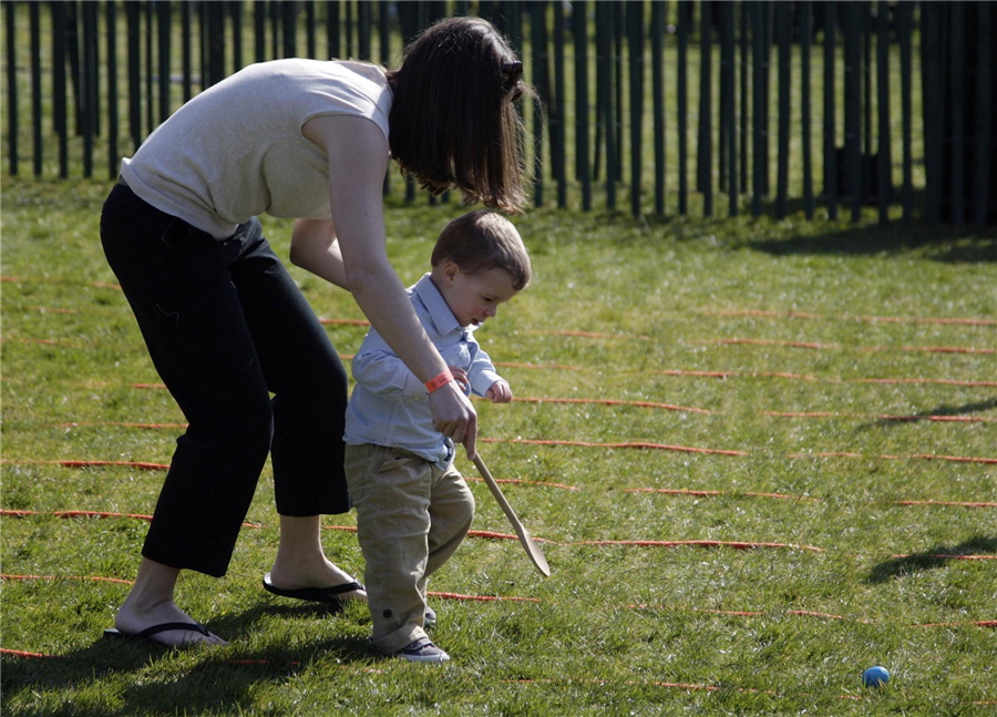A boy gets help with his egg in the annual Easter Egg Roll on the South Lawn of the White House in Washington, April 1, 2013. Obama family enjoys Easter Egg Roll with children