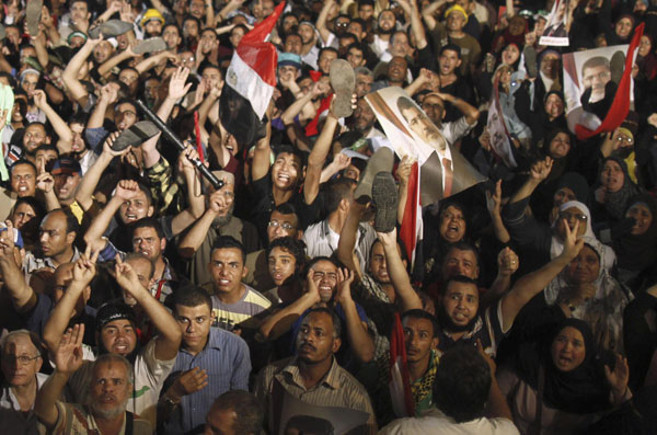 Members of the Muslim Brotherhood and supporters of Egypt's President Mohamed Mursi react after the Egyptian army's statement was read out on state TV, at the Raba El-Adwyia mosque square in Cairo July 3, 2013. Jubilant crowds celebrate after Morsi overthrown